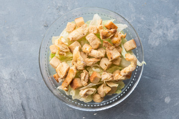 Caesar salad with toast, lettuce and grilled chicken breast