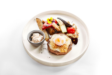 Steak with sous vide egg and baked vegetables