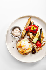 Steak with sous vide egg and baked vegetables