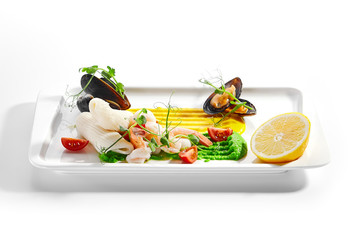 Blanched seafood, cut tomatoes and lemon