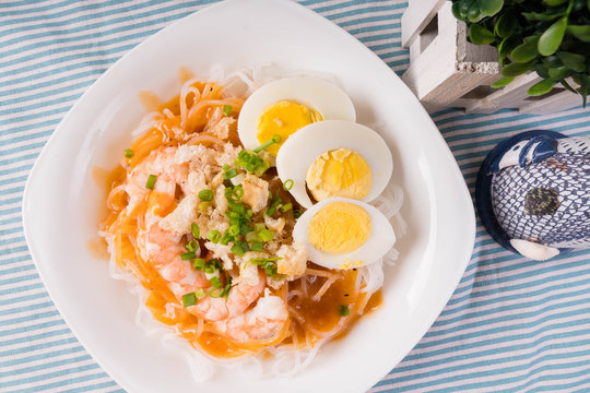 thick rice noodles with shrimp sauce, crispy pork skin and boiled egg also known as palabok