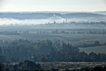 Panorama of light fog covered autumn countryside