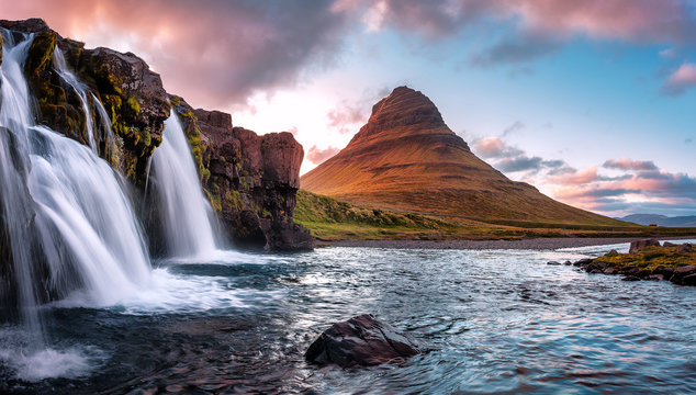 Scenic image of Iceland. Great view on famouse Mount Kirkjufell With Kirkjufell waterfall during sunset. Wonderful Nature landscape. Popular Travel destinations. Picture of wild area.