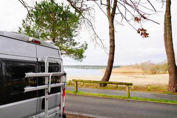 campervan rear parked on lake side in summer vanlife day