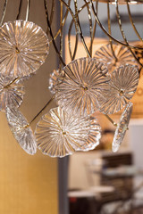 Crystal modern chandelier, big decorative lamp in the form of glass flowers, designed for installation on ceilings.