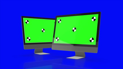 Two Modern computers with green screen, isolated on blue background . 3d render.