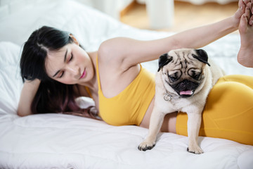woman practice yoga with dog pug breed