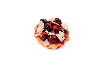 Amazing dessert in tartlet with cherry and white chocolate.