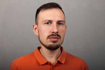 Obraz premium Portrait of a handsome man in an orange shirt