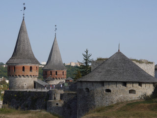 Medieval castle in the city of Kamyanets-Podilsky, Ukraine .  It is a formidable, strong fortress, whose walls are cut out of solid rock. The fortress stands at the top of a precipitous cliff . 