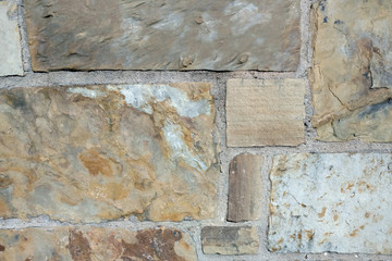 sand tan brown block cut slate rock wall close-up
