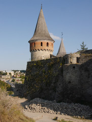 Medieval castle in the city of Kamyanets-Podilsky, Ukraine .  It is a formidable, strong fortress, whose walls are cut out of solid rock. The fortress stands at the top of a precipitous cliff . 