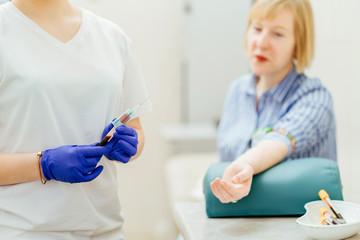 Nurse making boy blood sampling to test his health