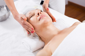 Fototapeta na wymiar Mature woman having face massage