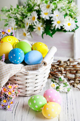 Obraz na płótnie Canvas Happy Easter. Congratulatory easter background. Easter eggs and flowers. Background with copy space. Selective focus.