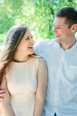 Fototapeta premium Young couple - girl and guy hugging at the nature park