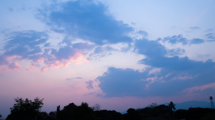 sunset sky horizontal with beautiful puffy fluffy clouds in pink colour light, abstract nature background