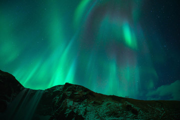 Beautiful Aurora at Skogafoss (Skoga Waterfall) in Iceland