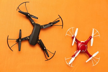 Black and red drones with propeller protection installed