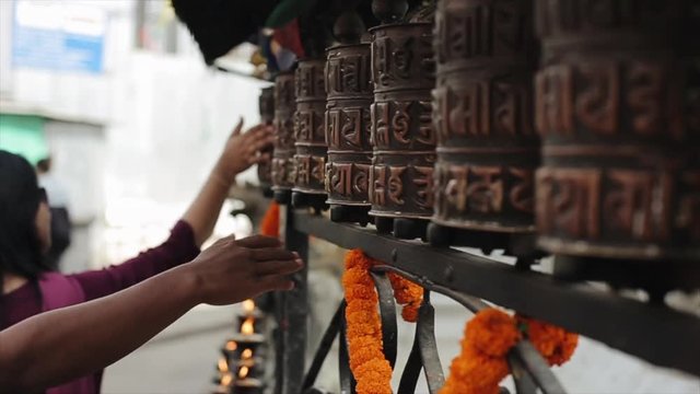 A close-up view nepalese people spinning prayer wheels. Kathmandu Nepal. Hands.