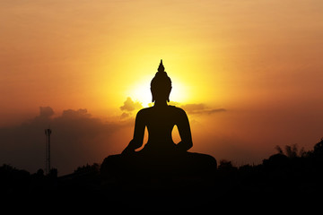 silhouette of buddha at sunset