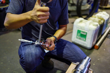 man adjust micrometer measure bore gauge