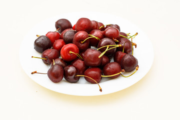Plate with group of delicious cherries