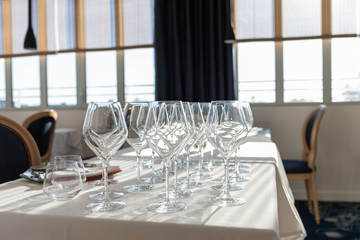 few empty glasses in a restaurant, restaurant interior, many transparent glasses on the table, catering, holiday
