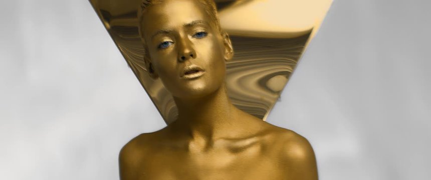nice sexy girl with Golden glossy skin moves or dances looking at camera, perfect female body shape, precious metal robot woman with blue eyes, creative art performance, anamorphic shot