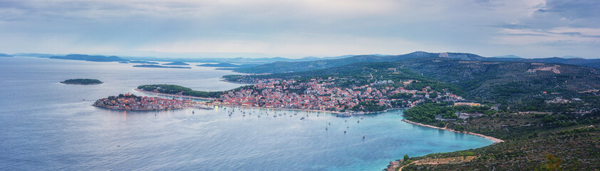 Fototapeta na wymiar Aerial view of famous tourist sea resort Primosten and Adriatic seacoast at sunset, Dalmatia, Croatia. Scenic panoramic landscape with town, sea, islands and sky, outdoor travel background