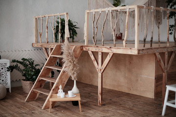 Breakfast set close up in the room. Coffee cup on a tray with statuette decoration. Selective focus. Boho style