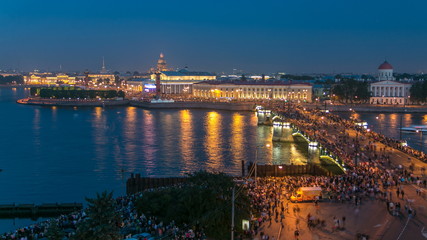 Fototapeta na wymiar Night view of spit of Vasilyevsky Island and Birzhevoy Bridge with rostral column timelapse, Saint Petersburg, Russia.