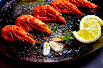 prawns fried with spices with sauce and lemon slices