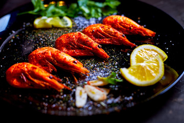 prawns fried with spices with sauce and lemon slices