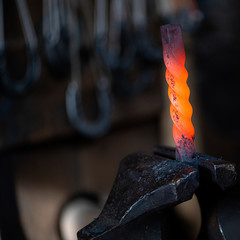 Close up of hot iron in blacksmith's workshop