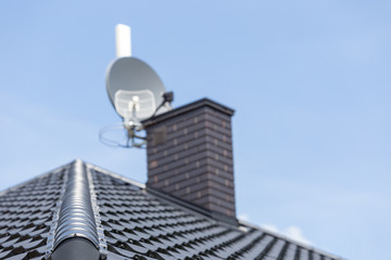 Obraz premium roof of the new modern house with ventilation chimney and satellite dish