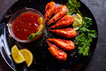 prawns fried with spices with sauce and lemon slices