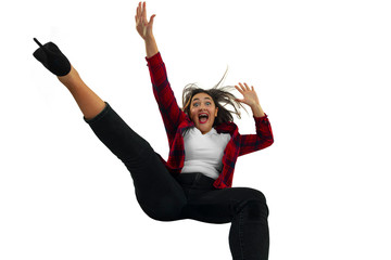 A second before falling. Caucasian young girl falling down in moment with bright emotions and facial expression. Female model in casual clothes. Shocked, scared, screaming. Copyspace for ad.