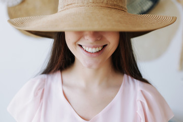 Young pretty happy woman in a dress. A beautiful smiling girl in a hat. Romantic shot. Fashion style photo of a spring women