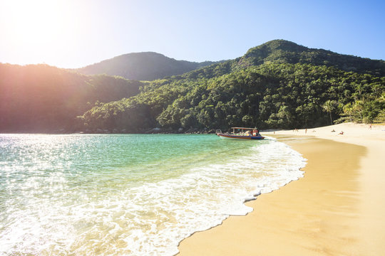 Vacation on the Meros(praia dos Meros) beach with clean sand, turquoise ocean water and blue sky with clouds on a sunny day. Panoramic view of the beach in Ilha Grande, south of Rio de Janeiro, Brazil