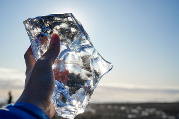 ice piece on hand in afternoon time make beautiful reflect light on ice