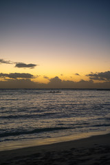 Outrigger Canoe Silhouetted at Sunrise on the Pacific Ocean in Hawaii