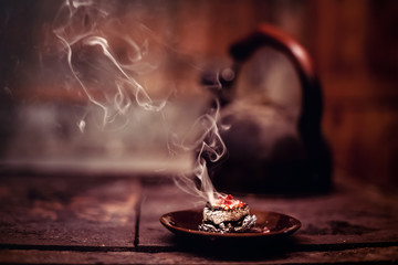 Obraz na płótnie Canvas Frankincense burning on a hot coal. Aromatic frankincense.