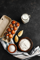 Ingredients for making pancakes. chicken eggs, whisk, flour, sugar, lemon. the view from the top place for text