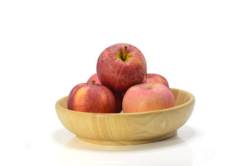 red apple in wood bowl on white background.
