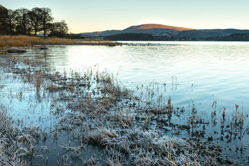 A frosty winter sunrise at Bassenthwaite Lake in the Lake District National Park, Cumbria, England.