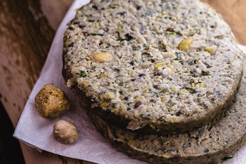 vegan hamburger based on various vegetables, raw, without frying, on wooden background.Vegan food and healthy living concept.