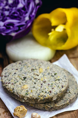 vegan hamburger based on various vegetables, raw, without frying, on wooden background.Vegan food and healthy living concept.