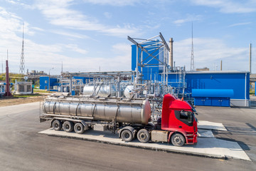 pouring chemical components into a tanker at the factory
