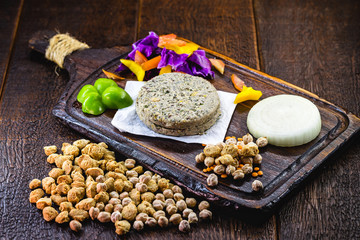 Fototapeta na wymiar Vegan dessert or snack. Meatless food based on various vegetables, seeds and protein, such as soybeans, chickpeas, tomatoes, onions, red cabbage, peppers and others. Concept of healthy life or diet.